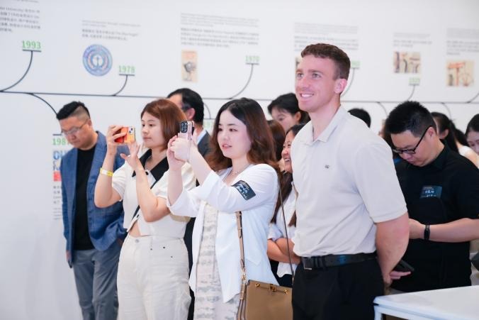Delegates, scholars, and industry representatives attending the Designing for the Real World: A Decade of the Sustainable Development Goals exhibition at WAIC 2026.